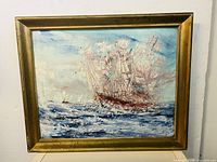 Full view of framed oil painting showing a large sailing ship at sea with textured brushstrokes and blue waves.