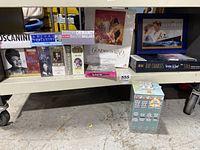 Shelf view of various new old stock music CD box sets including classical and jazz artists, plus blockbuster movie editions. All are visibly still in shrink wrap.