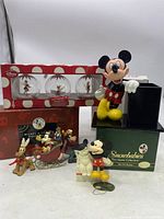 Full lot showing all items including Mickey Mouse pencil holder, Snowbabies box, Mickey & Friends sleigh figurines, and Tinker Bell snowball ornaments in original box