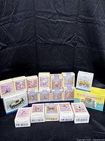 Multiple Hallmark Keepsake Easter ornaments in their original boxes arranged on a black backdrop.