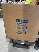Closed cardboard box showing Fisher brand and model DS-810 speaker system label