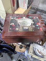Photo of the unopened, dusty box showing the Lenox Holiday covered warmer with rack and candle holder.