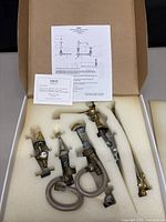 Whole faucet set packed in box with foam inserts and installation instructions displayed.