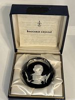 Photo showing the Baccarat Crystal paperweight resting in its original satin-lined blue presentation box.