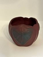 Front top-down view of mulberry pottery vase showing butterfly motif and petal-like texture around the rim.