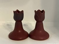 Two mulberry Van Briggle candlesticks with tulip-shaped tops, viewed side by side.