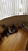 Wide view of lot near window showing multiple boxes containing watch repair tools, display albums, prints, and other items