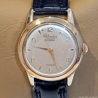 Clear front-facing close-up showing watch dial, brand, and condition.