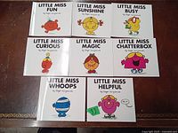 Photo showing all 8 Little Miss books arranged on a table, titles and characters visible.