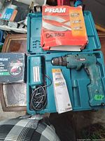 Photo showing Makita cordless drill with battery charger in blue case, Fram CA353 filter box, two boxes of riding lawnmower tubes, and a small accessory box.