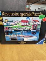 Photo of Ravensburger puzzle box showing the harbor image and 1000 piece count on the front