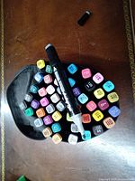 Top view of 48 assorted color markers arranged around one marker laying on a table