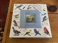 Front view of the birdwatching gift set box with bird illustrations and central bird window