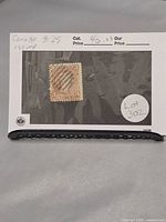 Canadian 3 cent red Large Queen Victoria stamp, postally used, mounted on black background with lot sticker visible.