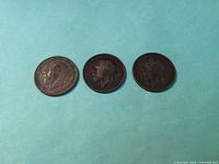 Obverse side showing portraits of King George V on the 1916, 1918, and 1927 pennies.