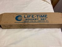 Closed rectangular cardboard box with Life-Time Socket Set branding in blue ink, labeled Crescent Tool Co. Jamestown N.Y.
