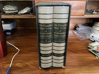Two hardcover volumes of The Complete Short Stories of W. Somerset Maugham in slipcase shown from the side, spines visible with gray covers and title labeling.