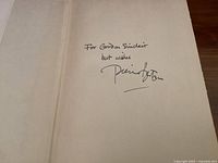 Handwritten personal inscription and signature of Pierre Berton inside the book addressed to Gordon Sinclair.