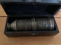 Brass Victorian marine telescope with maker's engraving inside original black lined wooden box, lid open, showing length and condition.