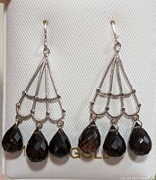 Front view showing pair of 14KT gold earrings with three dark brown faceted smokey quartz teardrop stones each.