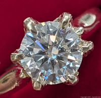 Close-up overhead view of round moissanite center stone in six-prong setting