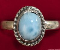 Close-up front view of the oval Larimar stone set in silver with twisted rope bezel