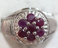 Close-up of the ring face showing the ruby cluster and silver setting.