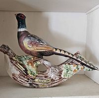 Porcelain pheasant figurine side view on branch base with Garnier label