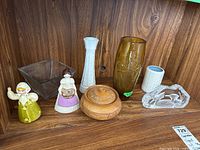 View of entire lot showing all items including vases, figurines, wood trinket dish, art glass piece and bobblehead