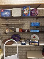 Front view of assortment of metal tins on shelves and white collapsible step stool in front