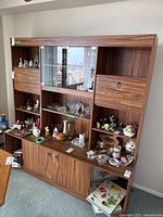 Wall unit filled with various decorative items for display to show shelving and cupboard arrangement
