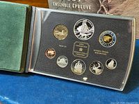 Full image of the proof set in green velvet case with clear plastic cover showing all coins and inscriptions in detail, including the Royal Canadian Mint mark and commemorative text.