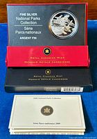 Photo of the coin and accompanying packaging from Royal Canadian Mint, showing the display case and certificate booklet.