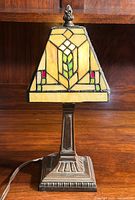 Front view of Tiffany style boudoir lamp showing stained glass shade and metal base