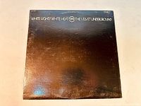 Front cover of Velvet Underground White Light/White Heat vinyl album showing original black cover with text.