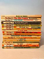 Stack of 18 vintage children's books showing all titles and worn spines, suitable to see condition and count.
