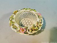 Top view of the vintage Belleek porcelain basket showing the open woven lattice design and flower-decorated rim