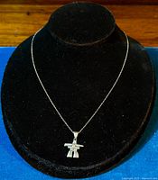 Necklace displayed on a black velvet stand showing full length with pendant centered.
