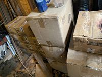 Cardboard cases stacked in storage area, containing the glasses and steins.