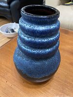 Side view showing textured ribbed blue glaze on pottery vase