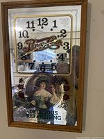 Front view of the rectangular vintage Pepsi-Cola advertising wall clock showing the wooden frame, mirrored face, black numerals, Pepsi-Cola logo, and vintage woman artwork.