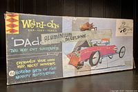 Photo of vintage Weird-Ohs 'Dad' Aluminum Airplane kit box with artwork and text describing the product.
