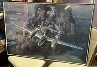 Framed art print showing a P-38 Lightning aircraft flying through stormy clouds and lightning.