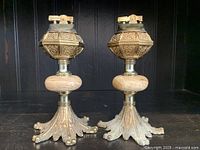 Pair of large vintage brass table lighters with wooden midsection and ornate detailed brass bases, approximately 6.5 inches tall each.