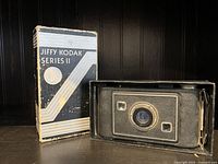 Photo of the Kodak Jiffy Series II folding camera and original box showing front side and packaging design.