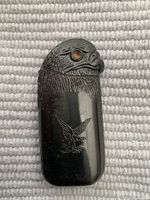 Photo of a vintage lighter shaped like an eagle's head with Harley Davidson eagle emblem and black case.
