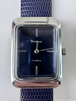 Front view of men's vintage Vendome watch rectangular case, blue dial with minimal markers, and silver-tone hands on blue textured leather strap.