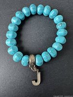 Full view of turquoise bead bracelet with J charm.