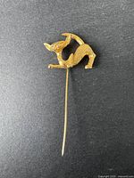 Front view of vintage D'ORLAN gold-tone cat brooch showing its shape and texture.