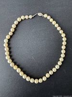 Full view of the round pearl necklace showing size and color of pearls.